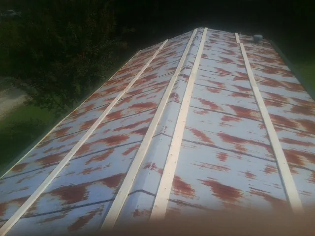 Rusted metal roof panels with new wood purlins before replacement — Storm Damage Roof Repair in Cashiers by Roofing Brothers